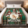 Tartan blanket with O'HALIE family crest on a bed.