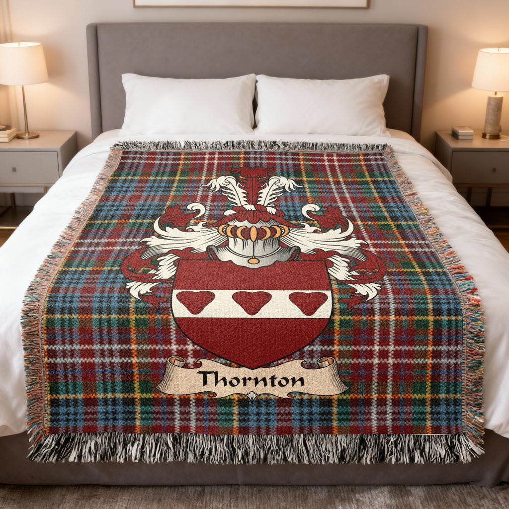 Thornton family crest emblem on a Caledonia tartan woven blanket