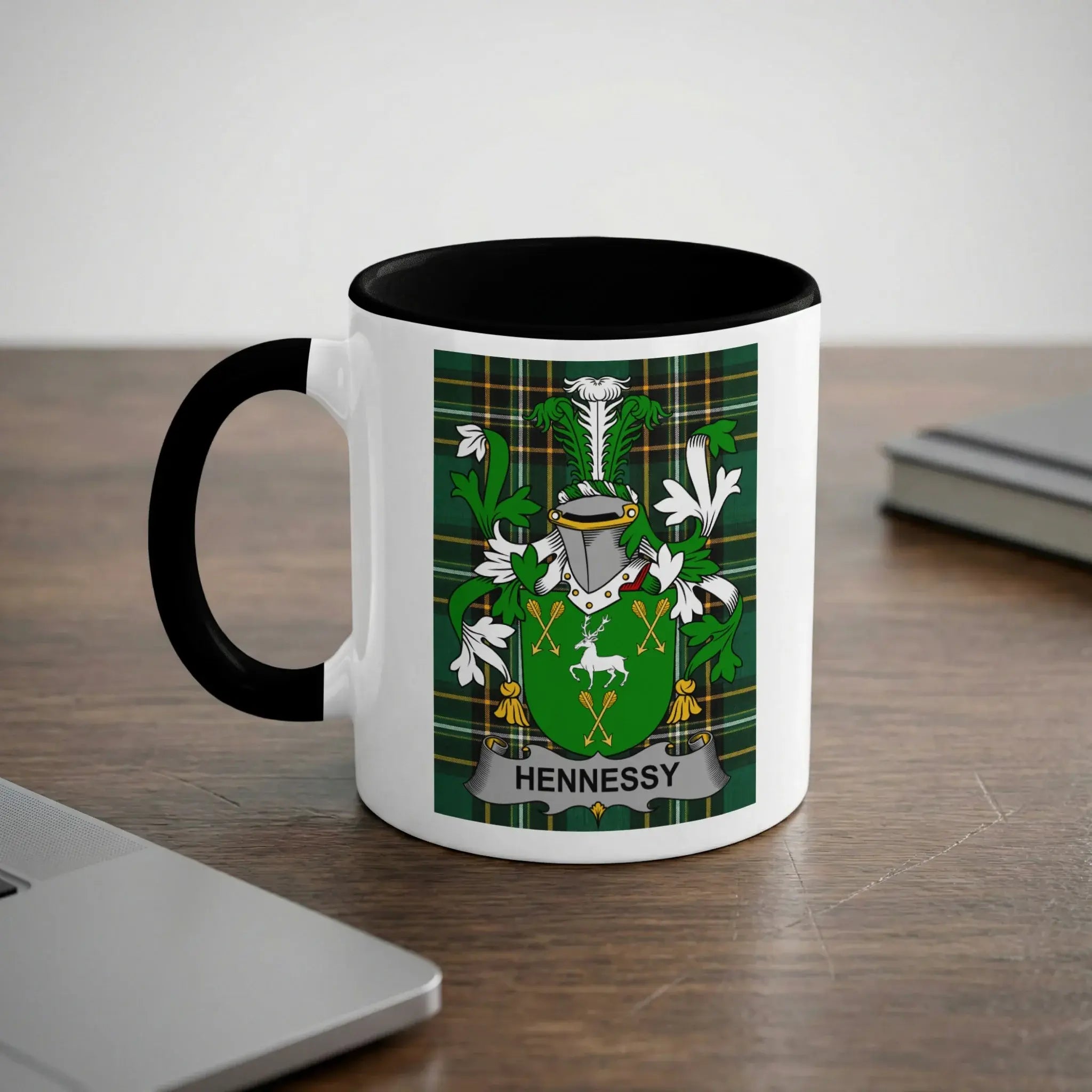 Mug with the Hennessy family crest on a wooden desk.