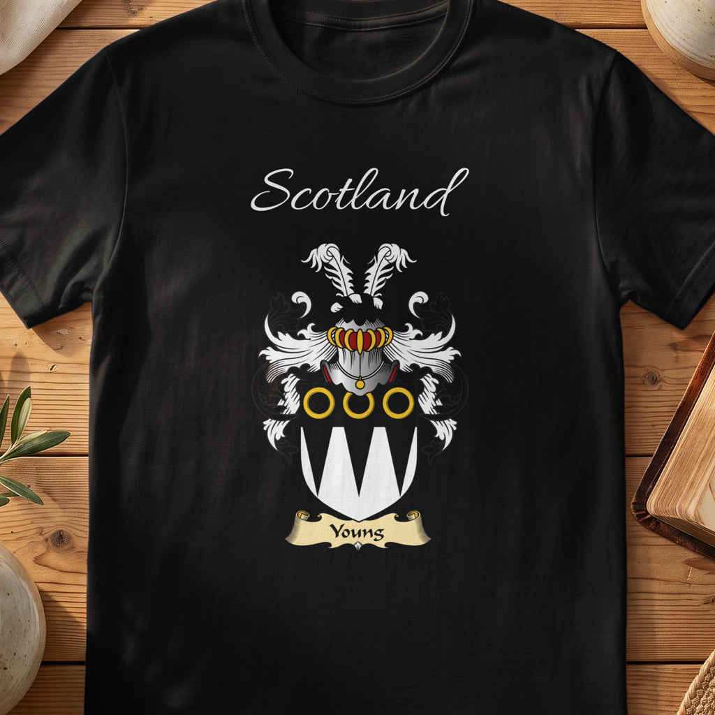Black Youngs Scottish family crest T-shirt laid flat, showing “Scotland” above a black-and-silver shield with pale pointed panels and gold rings.