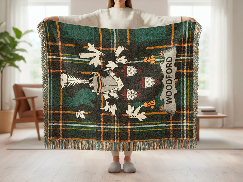 Tartan blanket with shield emblem and "WOODFORD" text, held by a person.