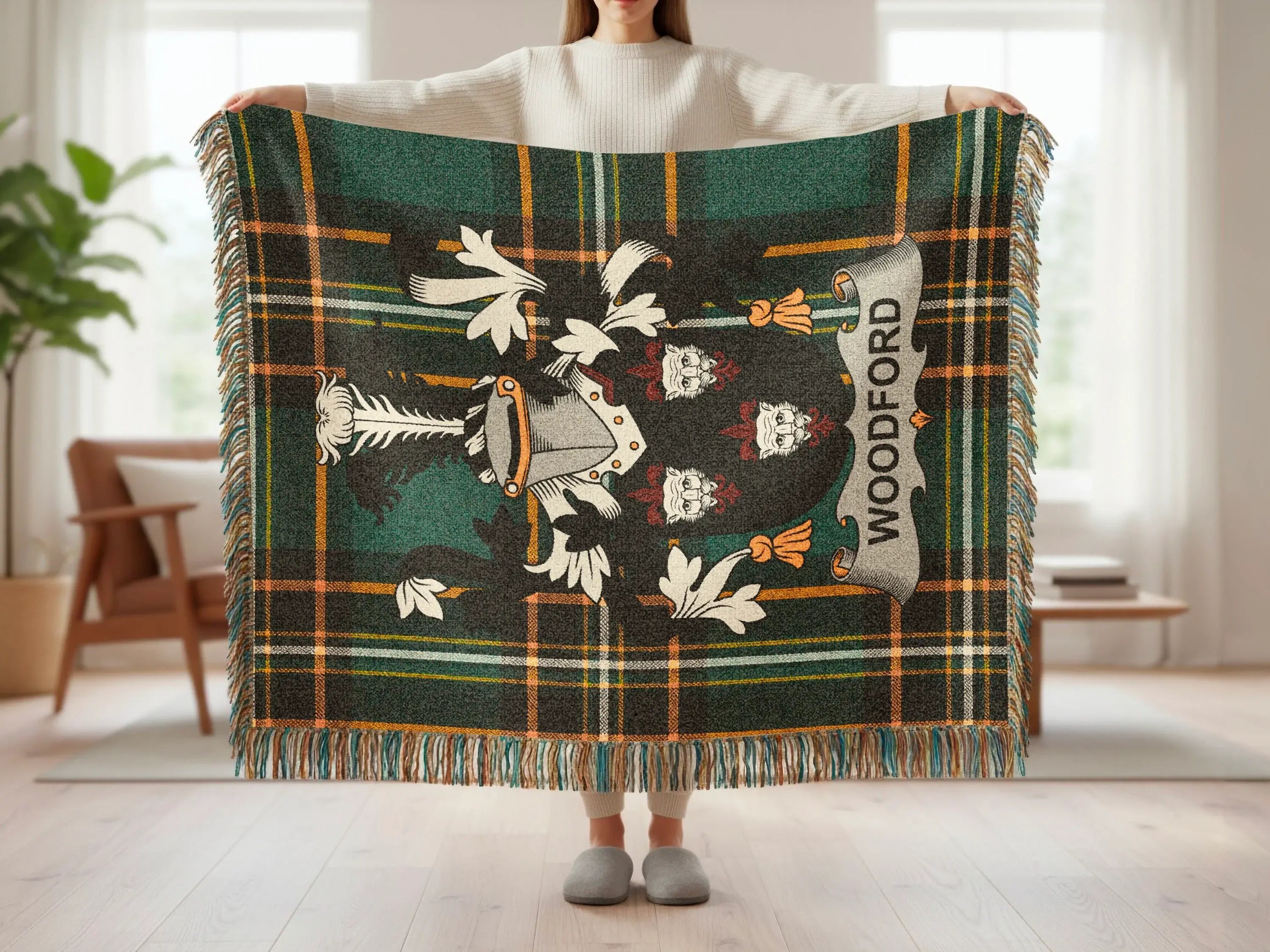 Tartan blanket with shield emblem and "WOODFORD" text, held by a person.