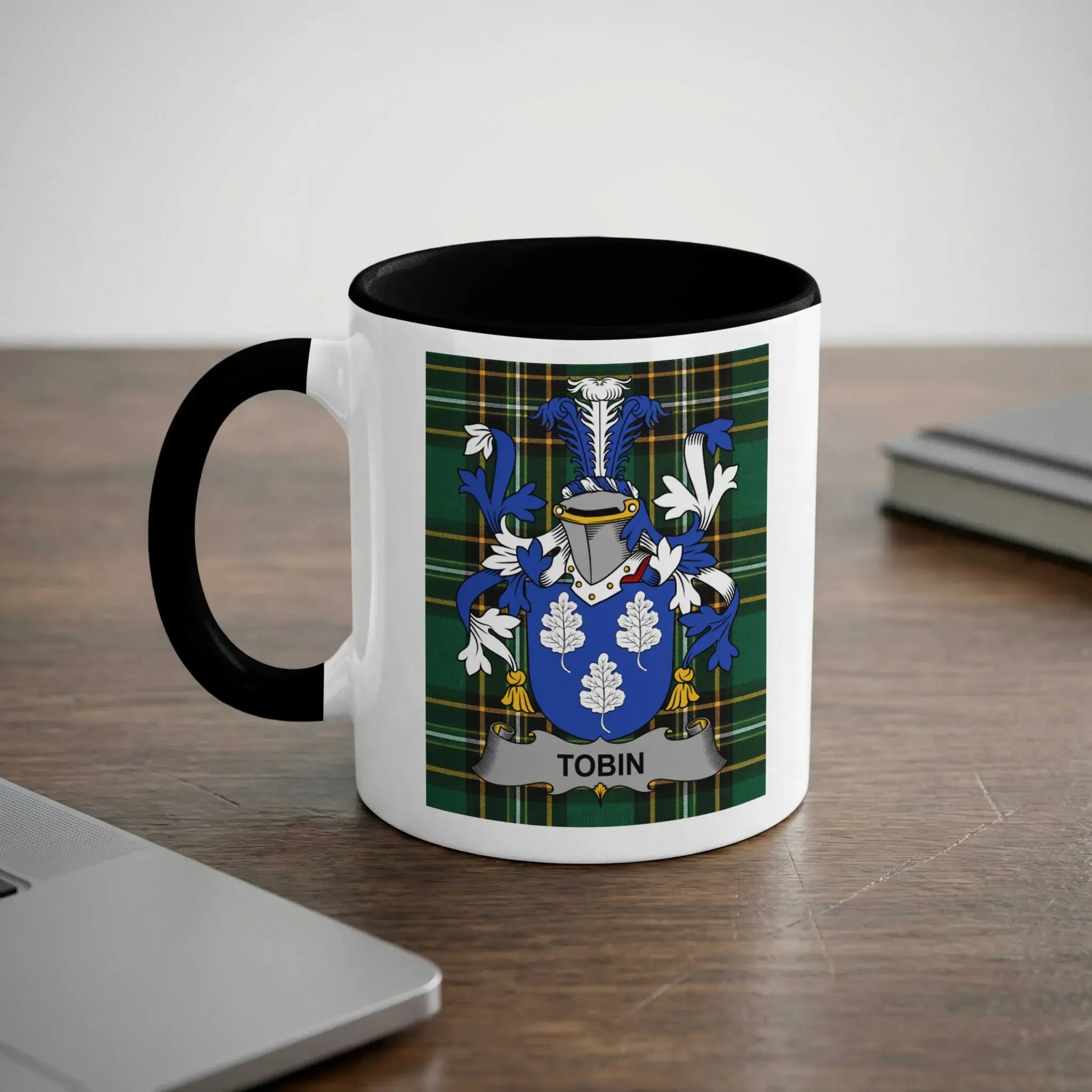 White mug with black handle featuring the Tobin family crest on a tartan background.