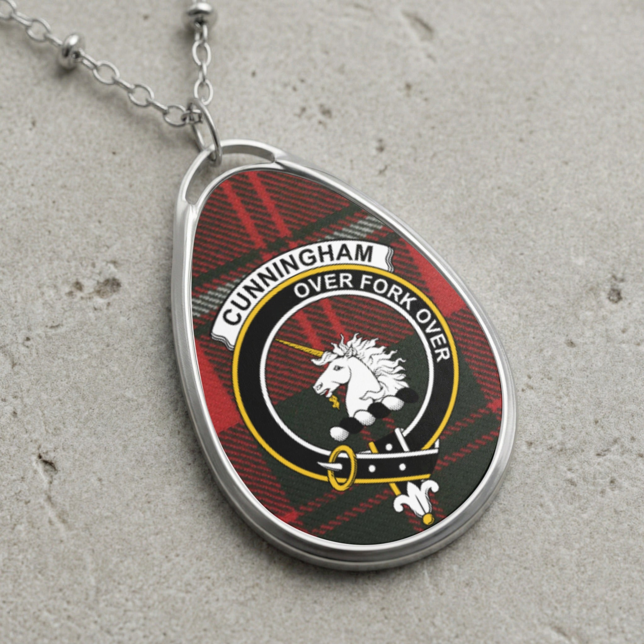 Cunningham clan Scottish tartan necklace with clan crest and Over Fork Over motto on tartan background