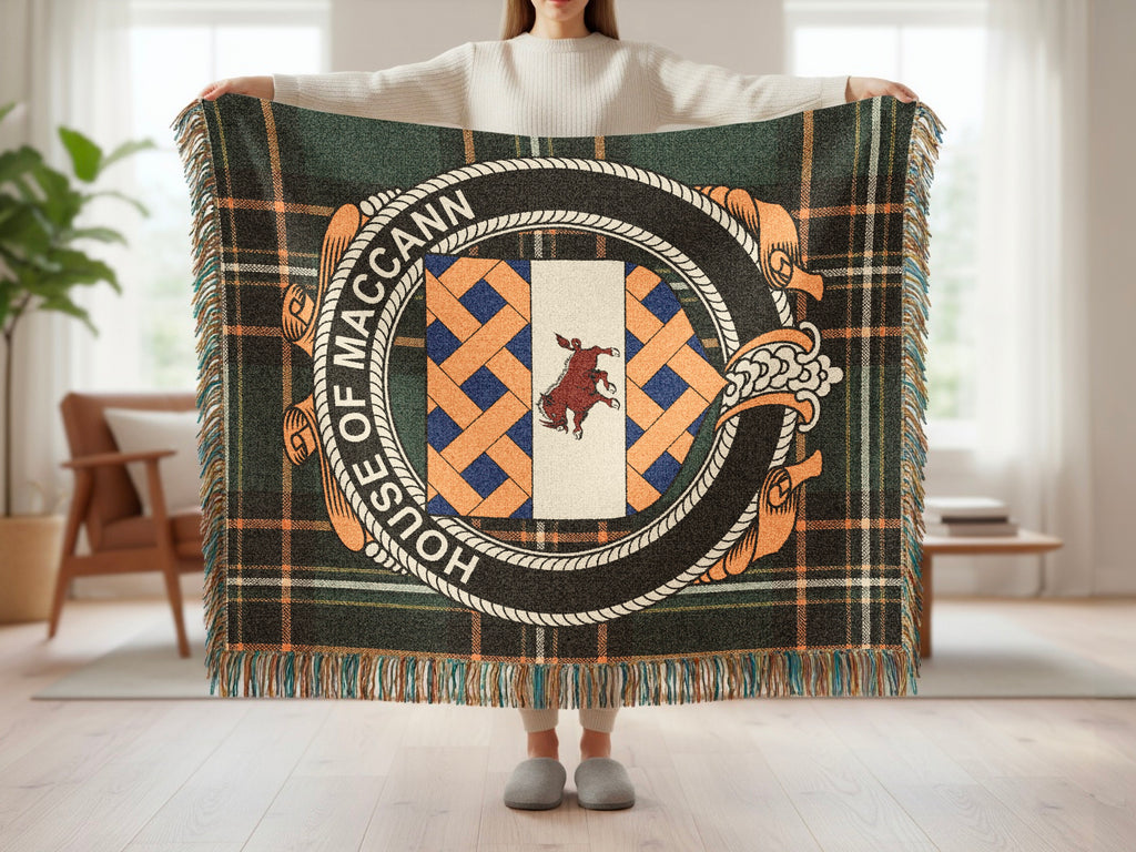 Person holding the House of MacCann family crest woven blanket open