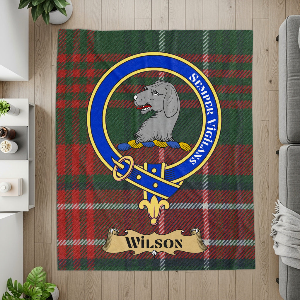 Wilson crest, motto and name banner on tartan printed throw — flat lay