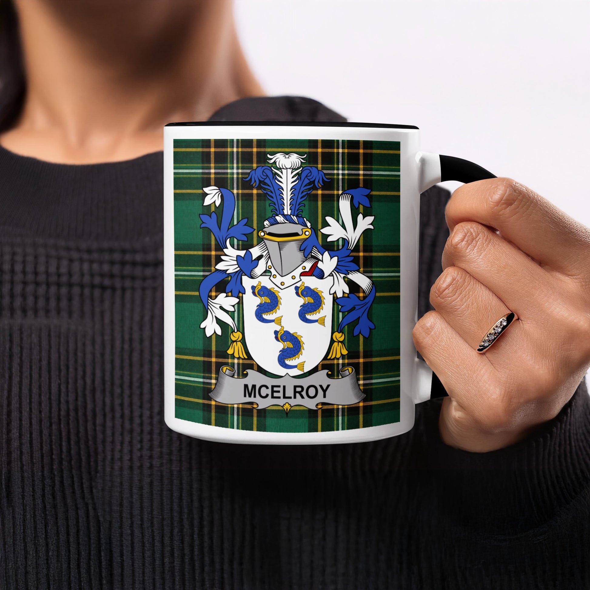 Mug with McElroy family crest on a tartan background.