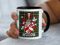White mug with Beasley family crest on tartan background.