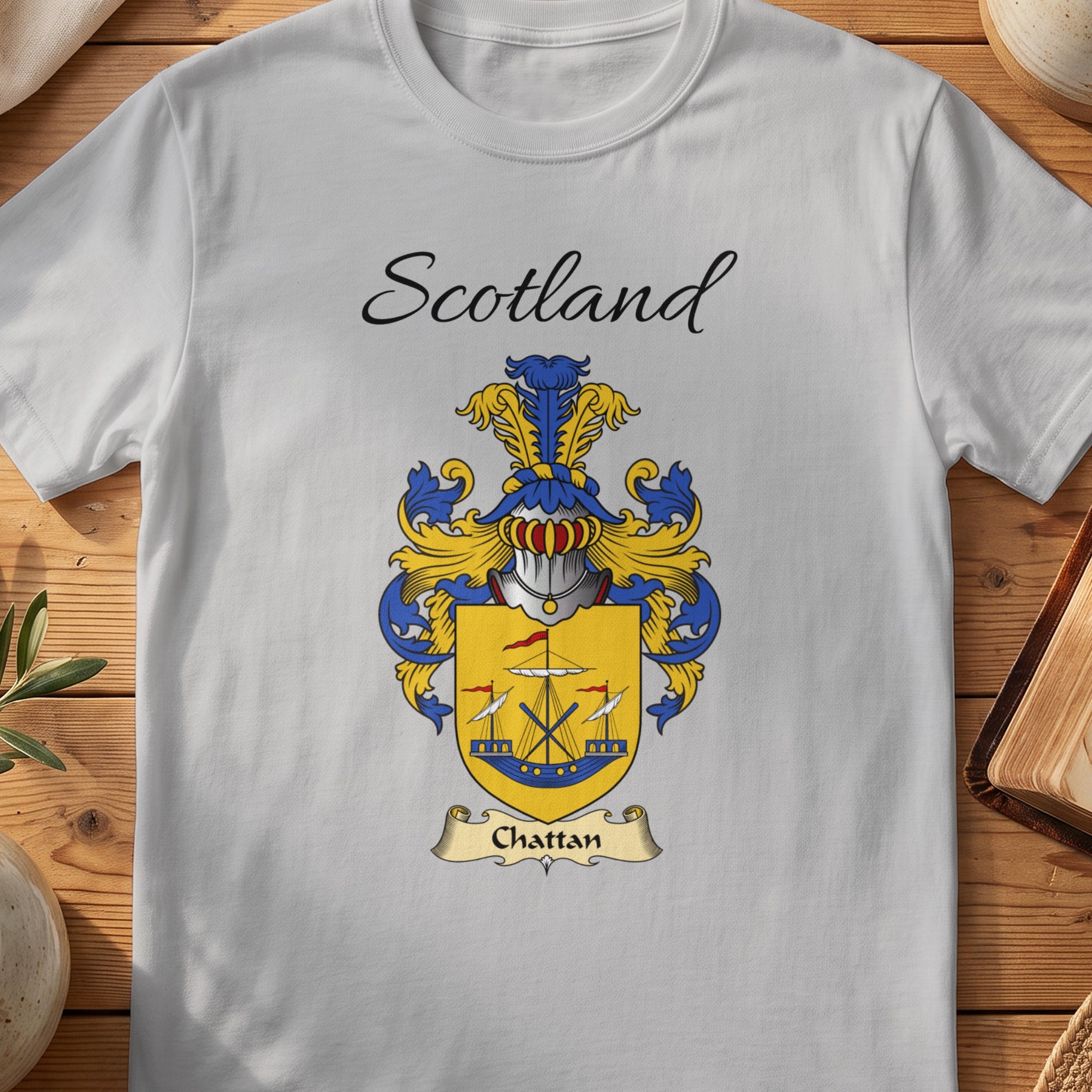 A light gray t-shirt featuring the Scotland Chattan clan crest printed on the chest.