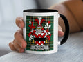 Mug with Blacke family crest on green tartan background.