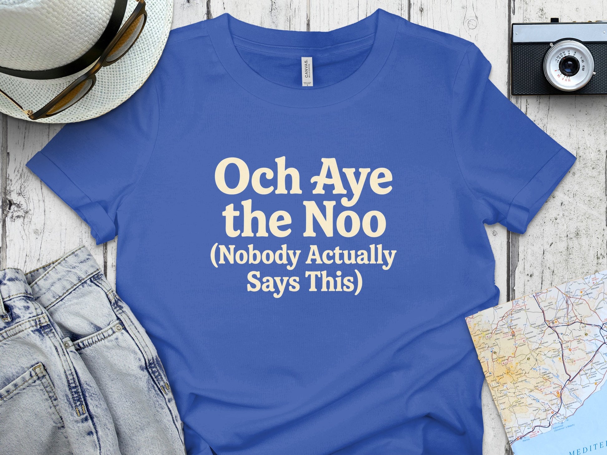 Blue t-shirt with "Och Aye the Noo (Nobody Actually Says This)" text.