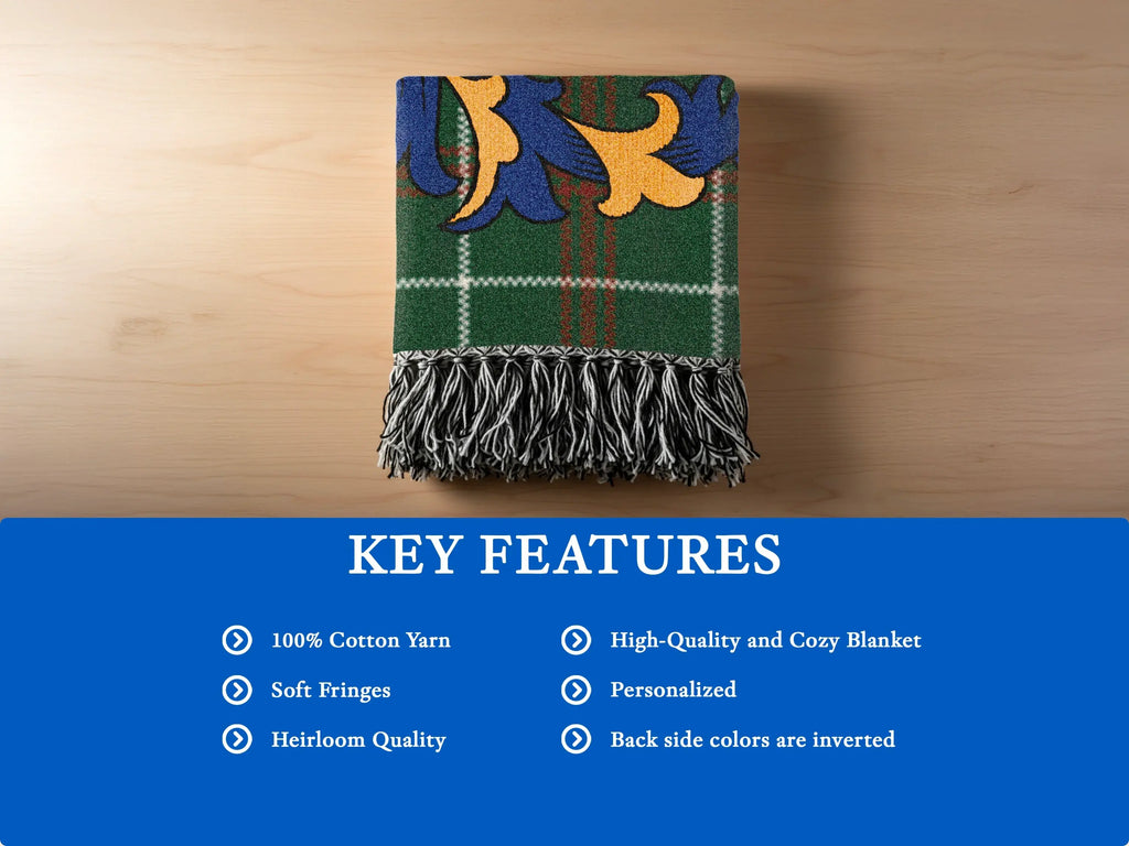 Green plaid blanket with blue and gold emblem and fringed edges.