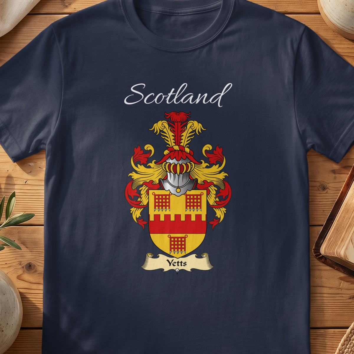 Navy Yetts heritage T-shirt laid flat with “Scotland” and the colourful family shield design.