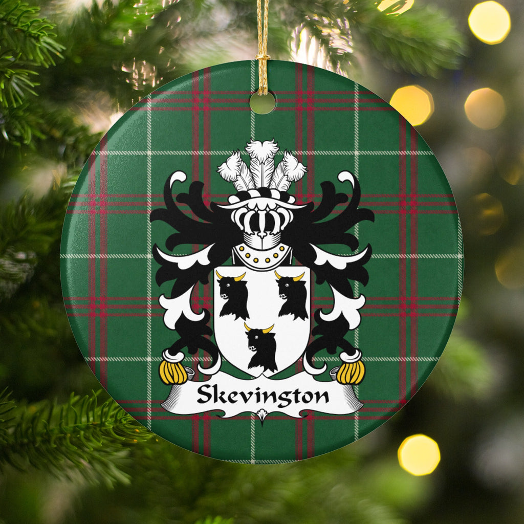 Skevington ornament hanging on a Christmas tree, with white shield with three black bull heads and gold horns on Welsh National Tartan.