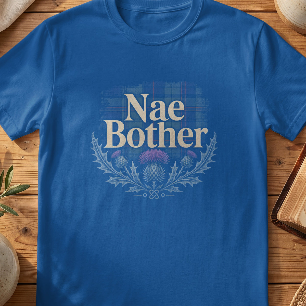 Royal blue t-shirt with "Nae Bother" text and thistle graphic.