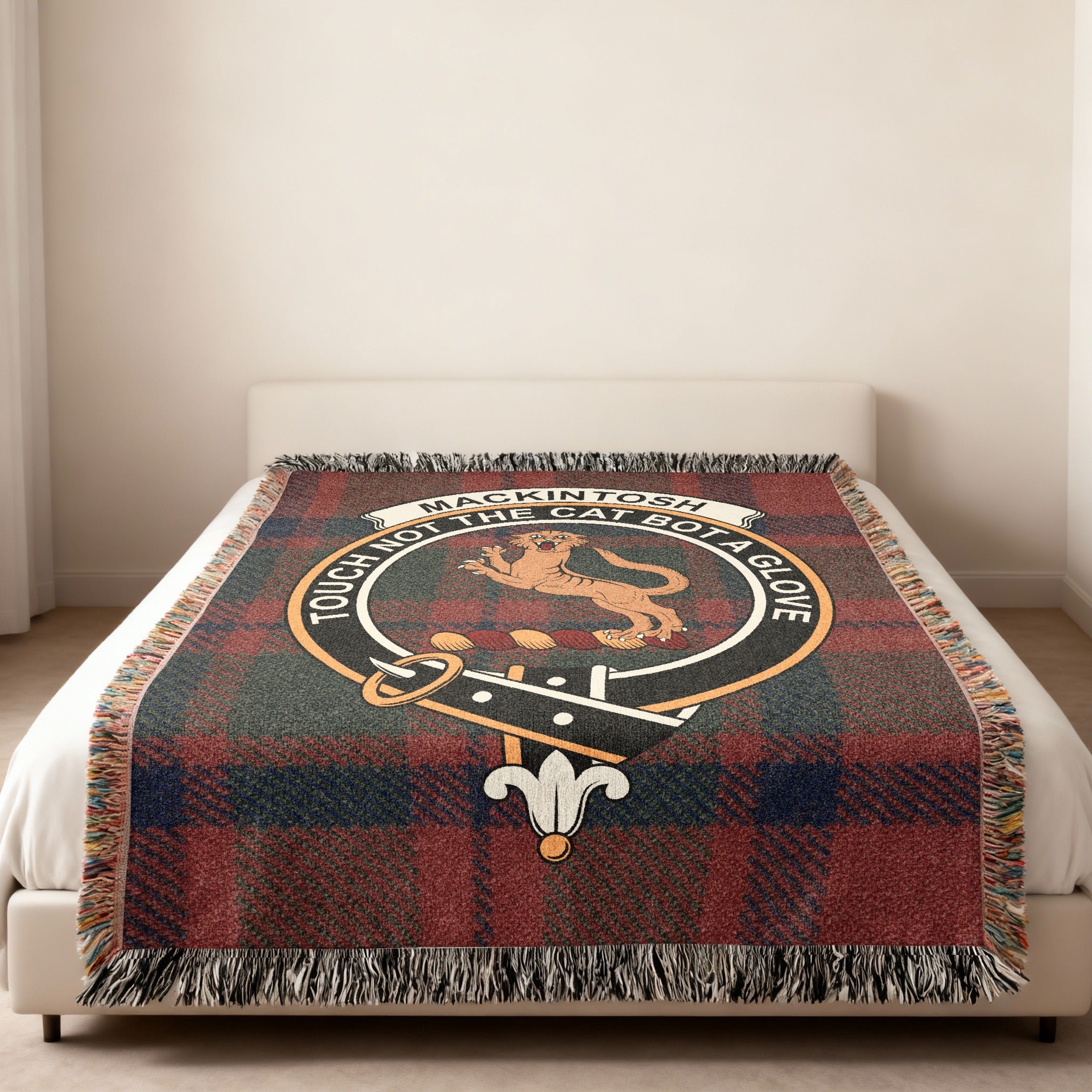 Mackintosh clan crest woven into tartan throw blanket — close-up