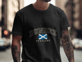 Model wearing the Black Dundee Scotland Comfort Colors T-shirt with the Scottish Saltire