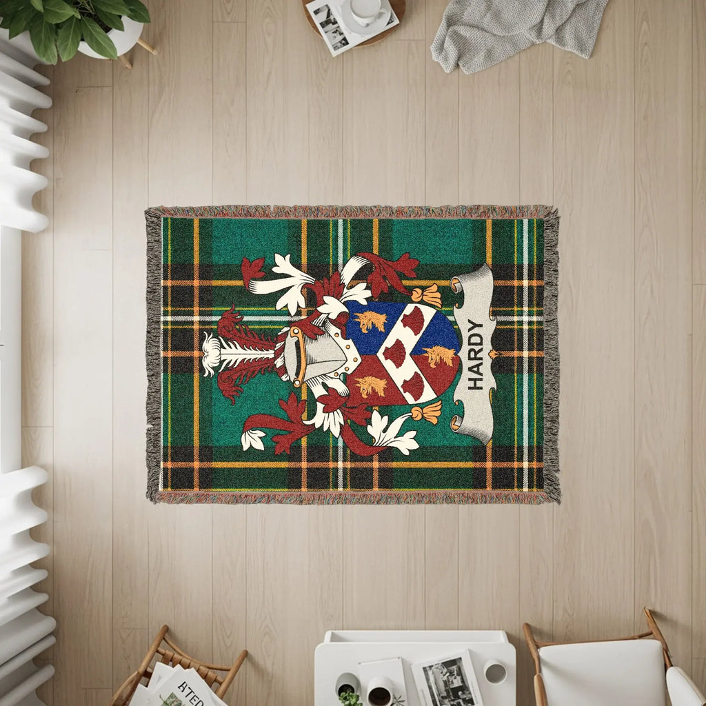 Hardy family crest on a green tartan plaid woven throw rug.