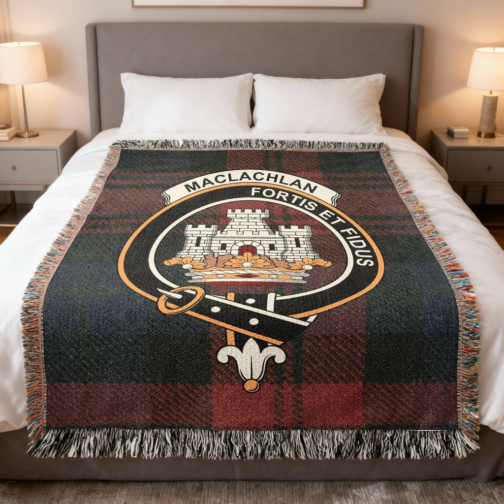 MacLachlan woven blanket displayed on a bed, with a castle above a crown on a red, green and blue tartan background