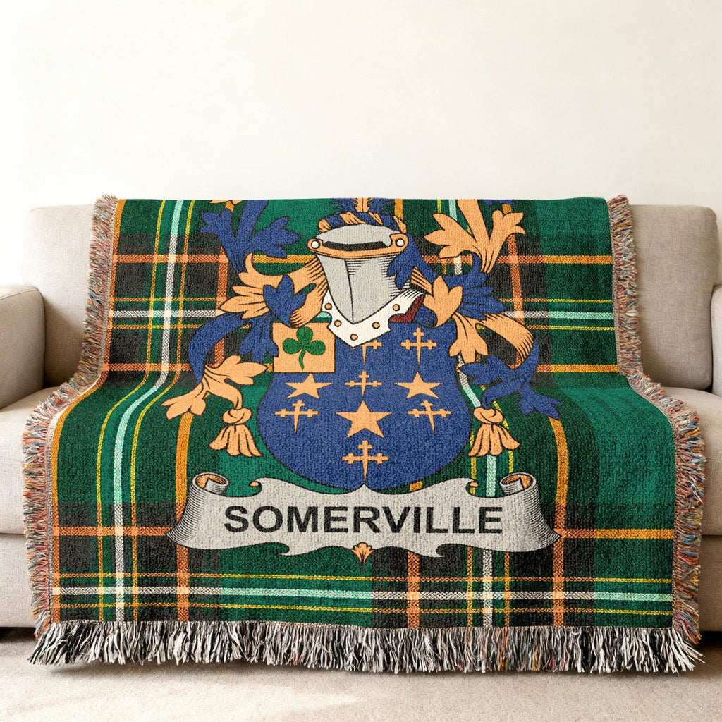 Somerville family crest on a green tartan plaid throw blanket.