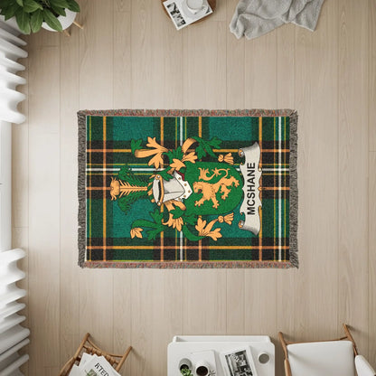 McShane family crest on a woven tartan throw blanket.