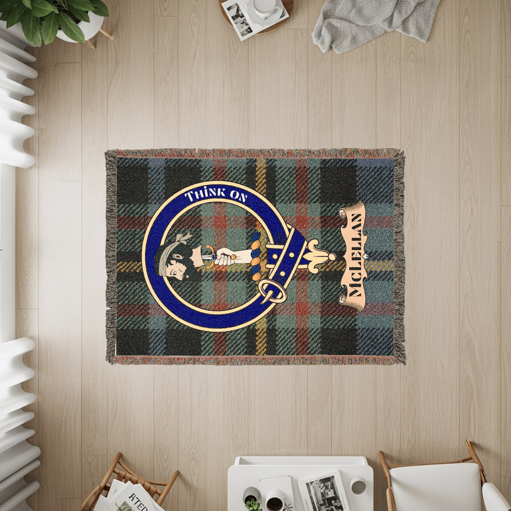 McLellan woven blanket displayed on a wall, featuring the crest badge and tartan background