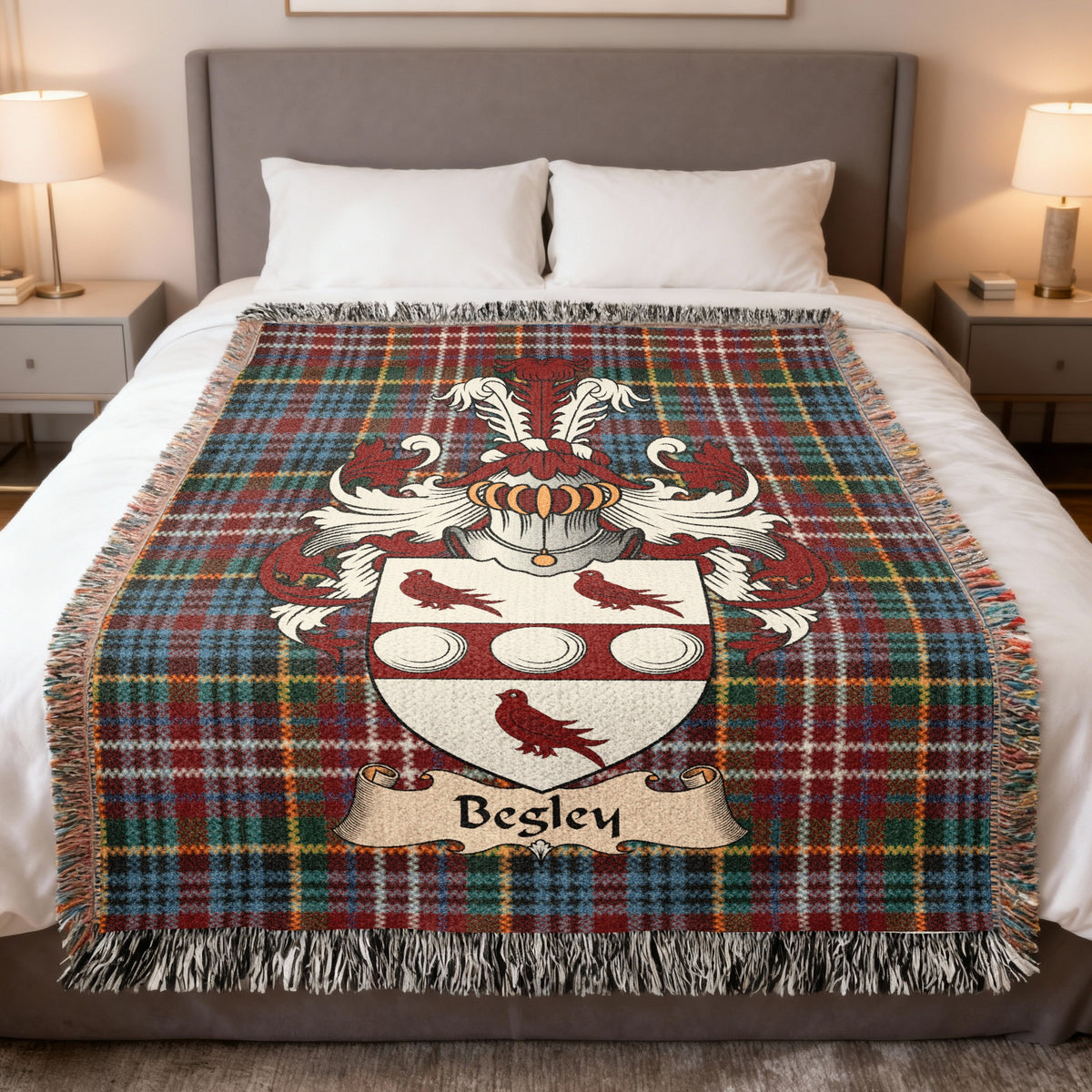 Begley Scottish family crest woven blanket on a Caledonia tartan background, displayed on a bed