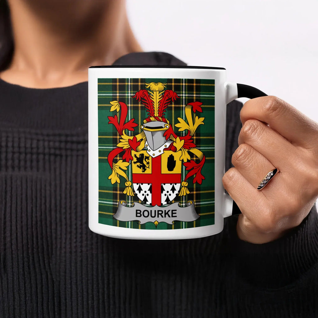 Black mug with "Bourke" coat of arms on green plaid background.