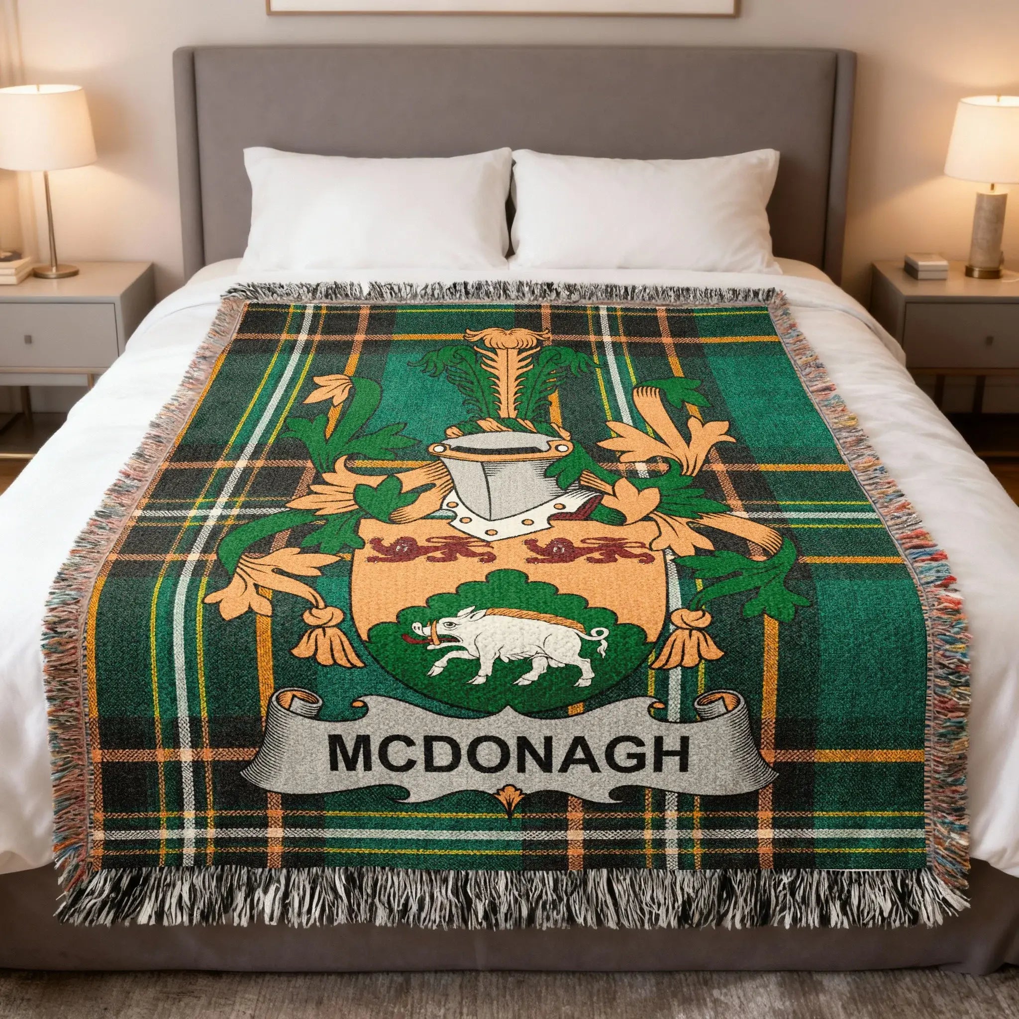 McDonagh tartan crest blanket with fringe, draped on a bed.
