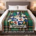 Sherman family crest on a green plaid woven blanket with fringed edges.