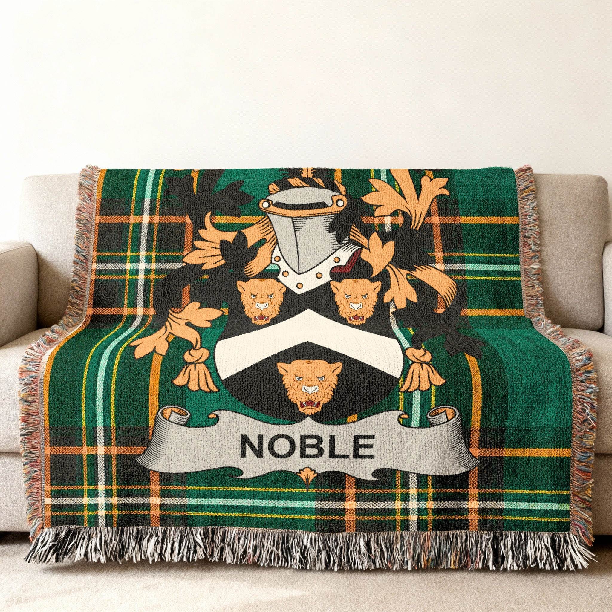 Plaid blanket with a family crest featuring a lion and the name "Noble".