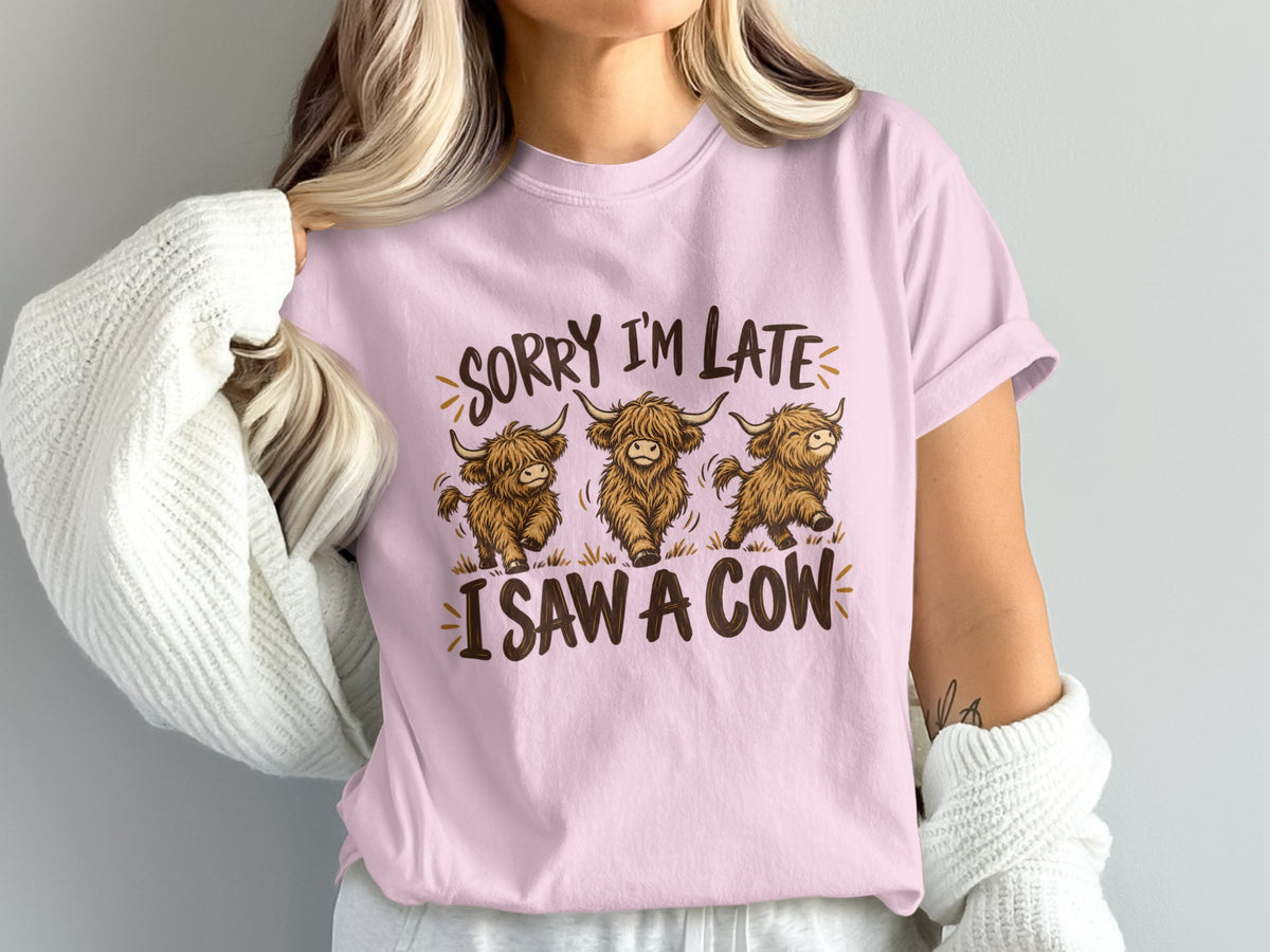 Model wearing the Sorry I'm Late, I Saw a Cow Highland cow Comfort Colors T-shirt in Blossom