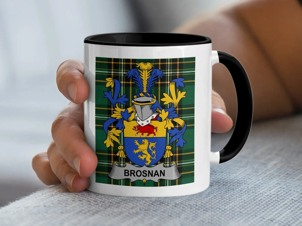 White mug with black rim featuring Brosnan family crest on a plaid background.