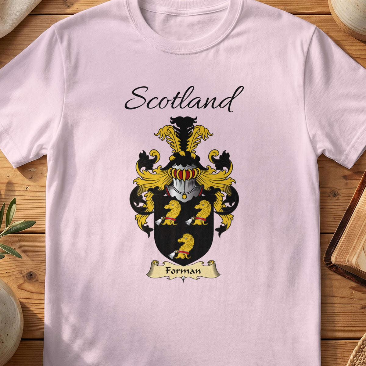 Light Pink Forman Scottish family shield T-shirt featuring three gold animal heads on black