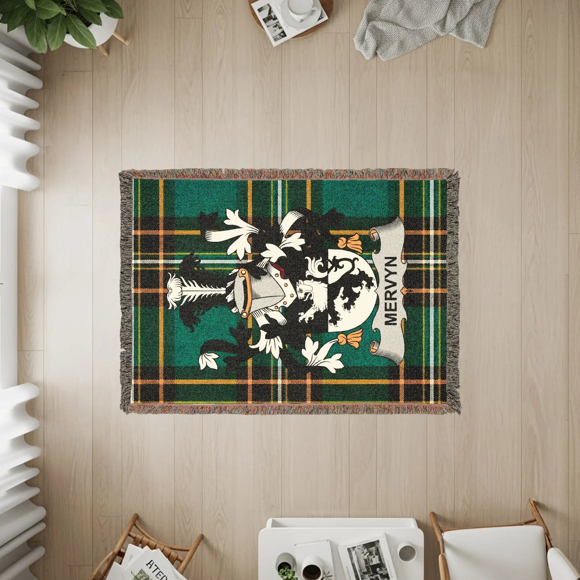 Mervyn clan crest on a woven blanket with plaid and fringe.
