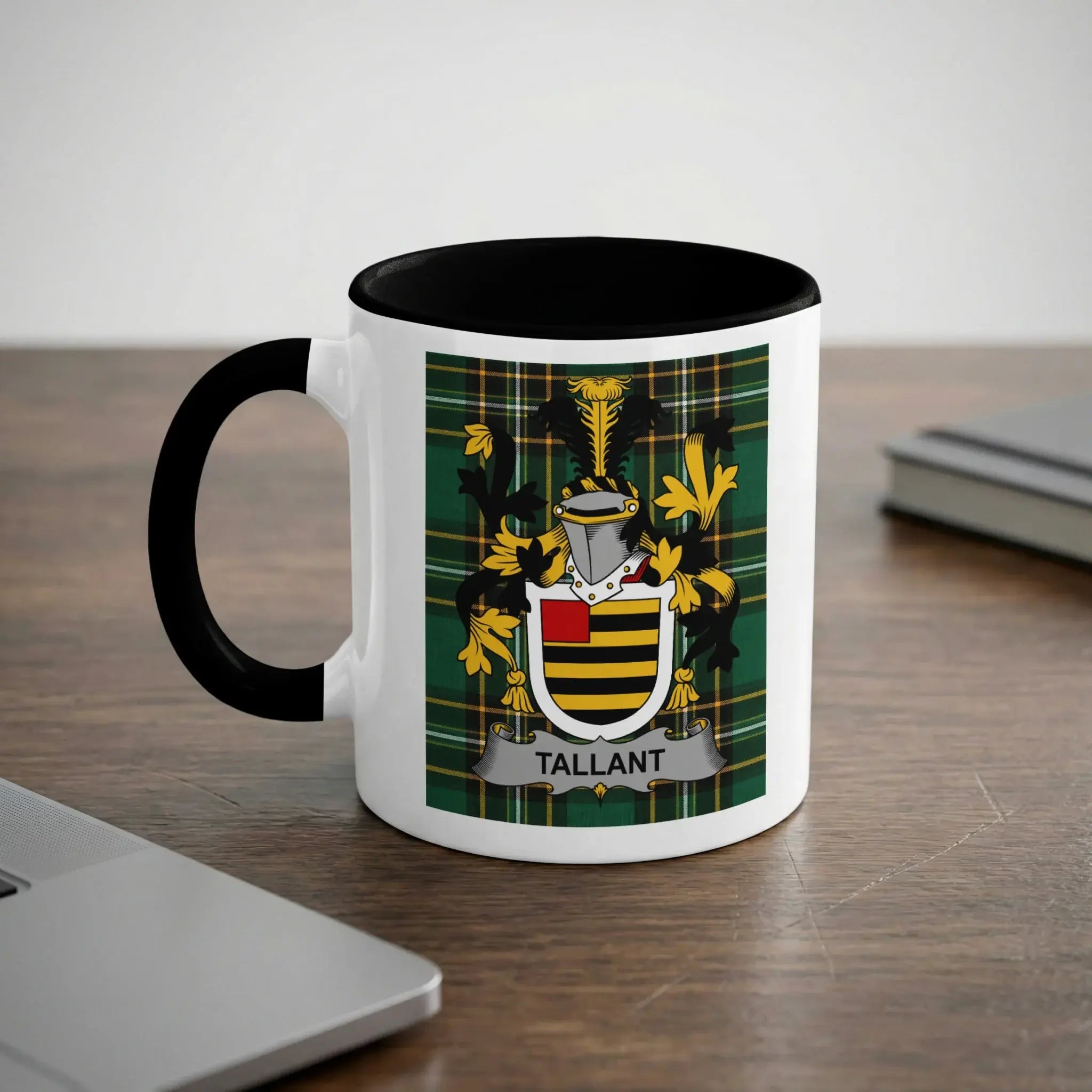White mug with black rim featuring the Tallant family crest on a green plaid background.