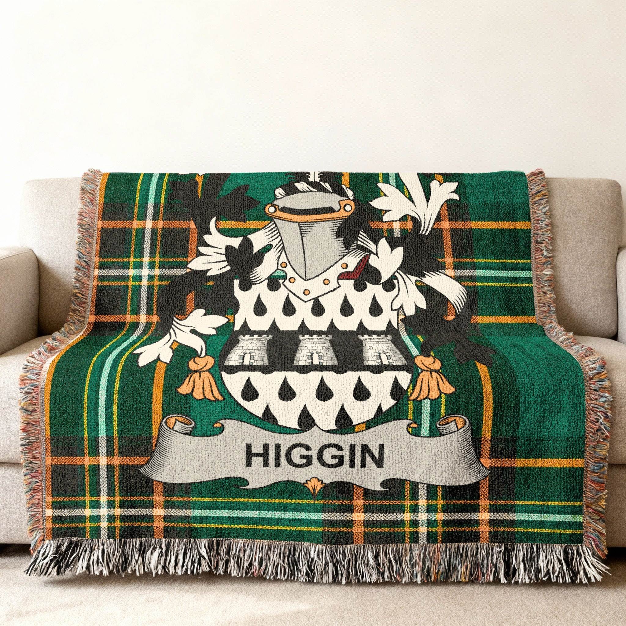 Tartan blanket with Higgin family crest on a sofa.