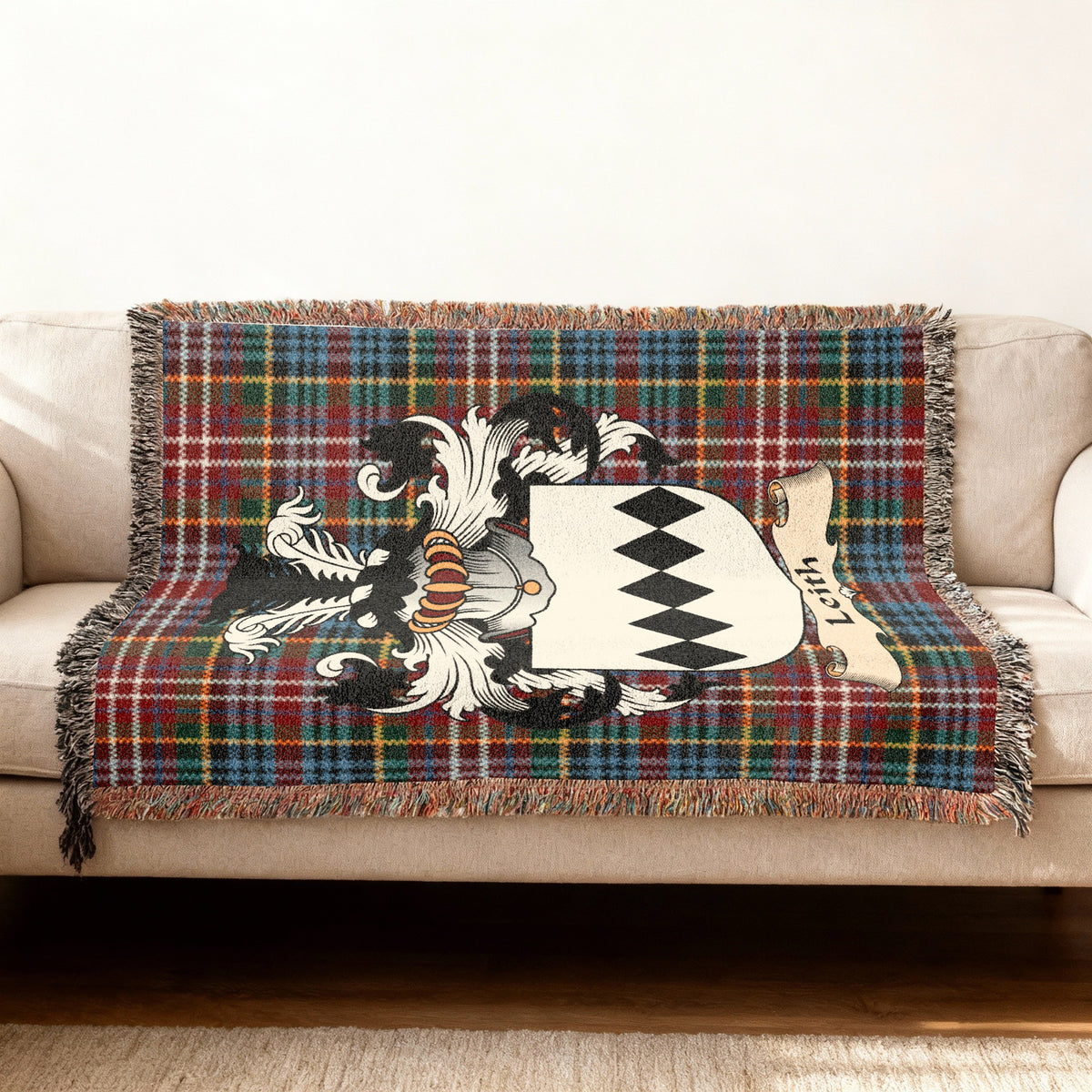 Leith Scottish woven blanket with family shield and Caledonia tartan background