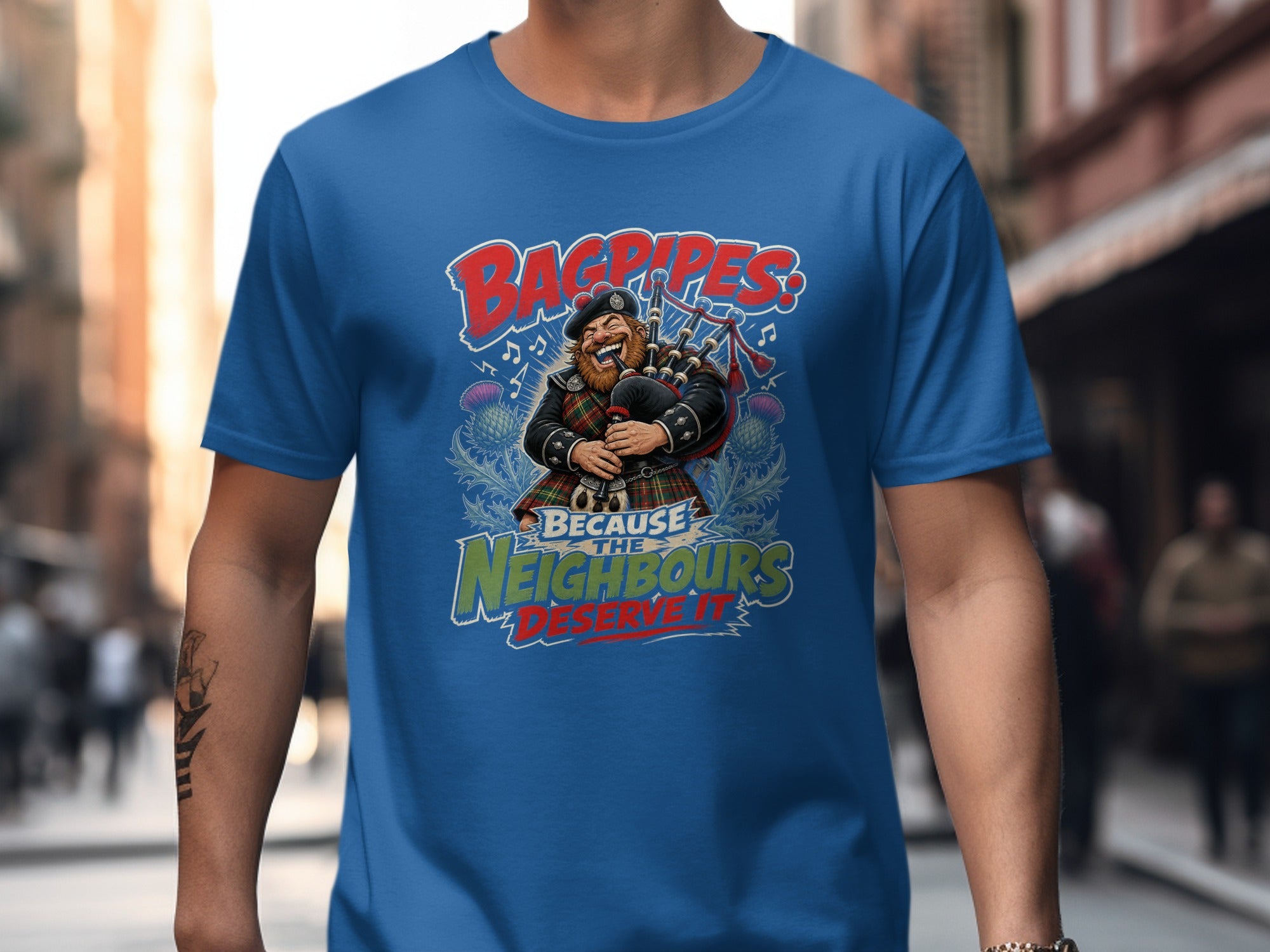 Blue t-shirt with a cartoon bagpiper and text reading "Bagpipes! Because the neighbours deserve it."
