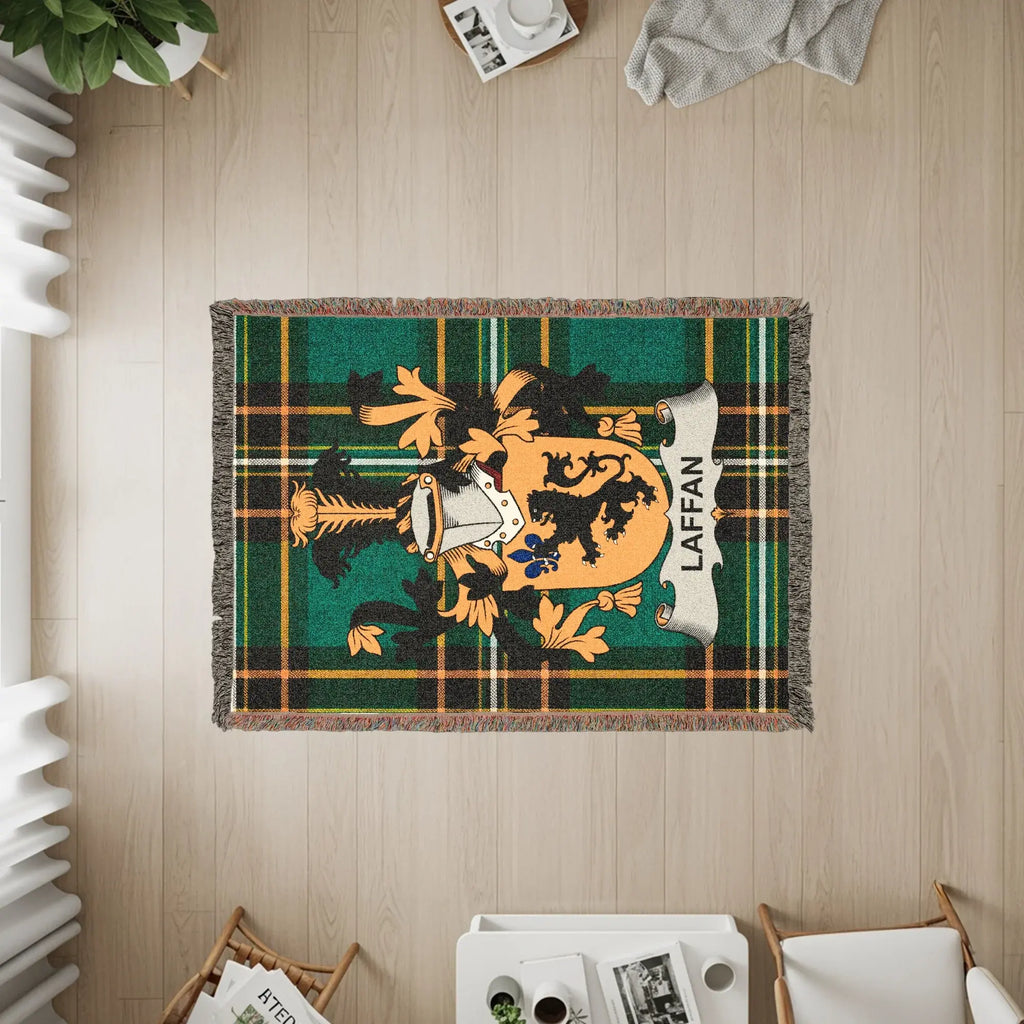 Green tartan blanket with Laffan coat of arms and fringed edges.