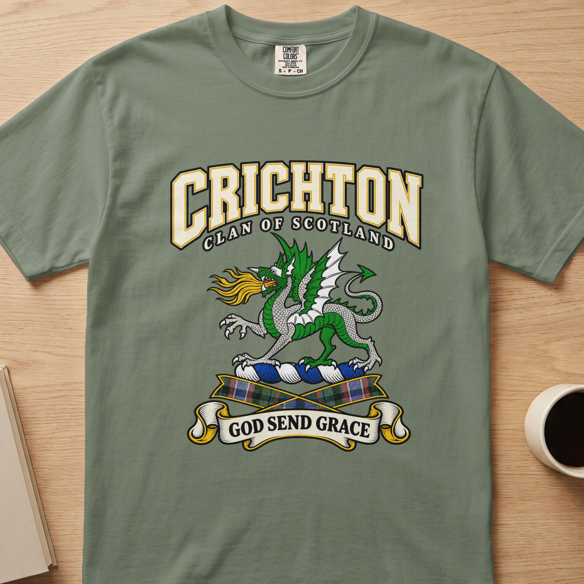 Crichton green dragon and tartan accents graphic on a sage green Comfort Colors T-shirt, front view
