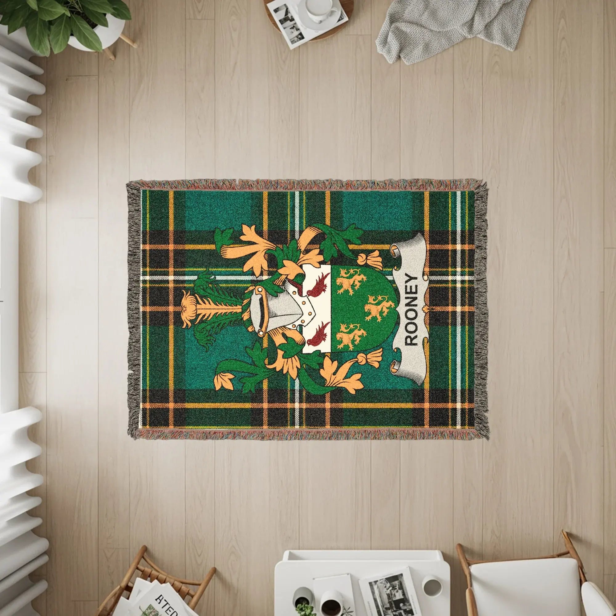 Rooney family crest on a green plaid woven blanket with fringe.