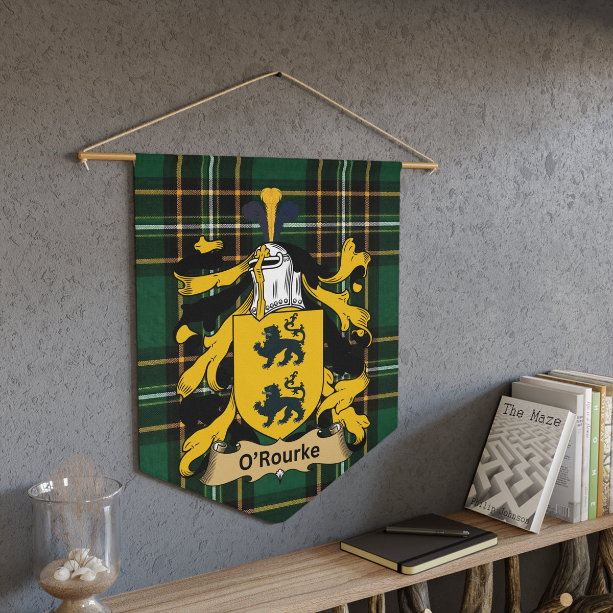 Tartan pennant with O'Rourke coat of arms hanging on textured wall.