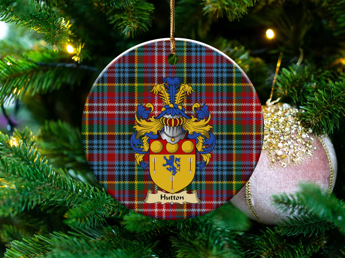 Hutton Scottish clan ceramic ornament with family crest on a Caledonia tartan background, hanging on a Christmas tree