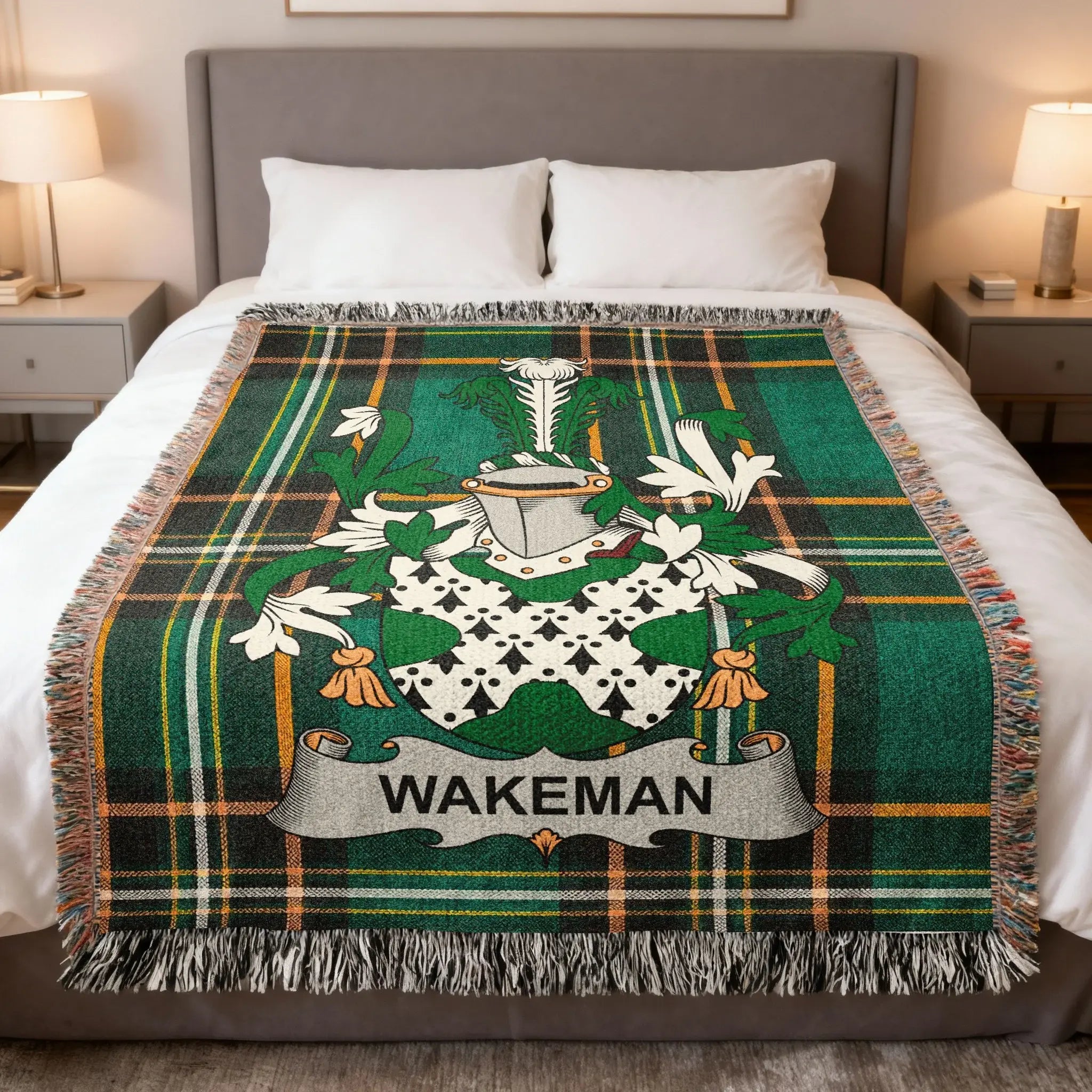 Wakeman family crest on a green tartan plaid blanket draped on a bed.