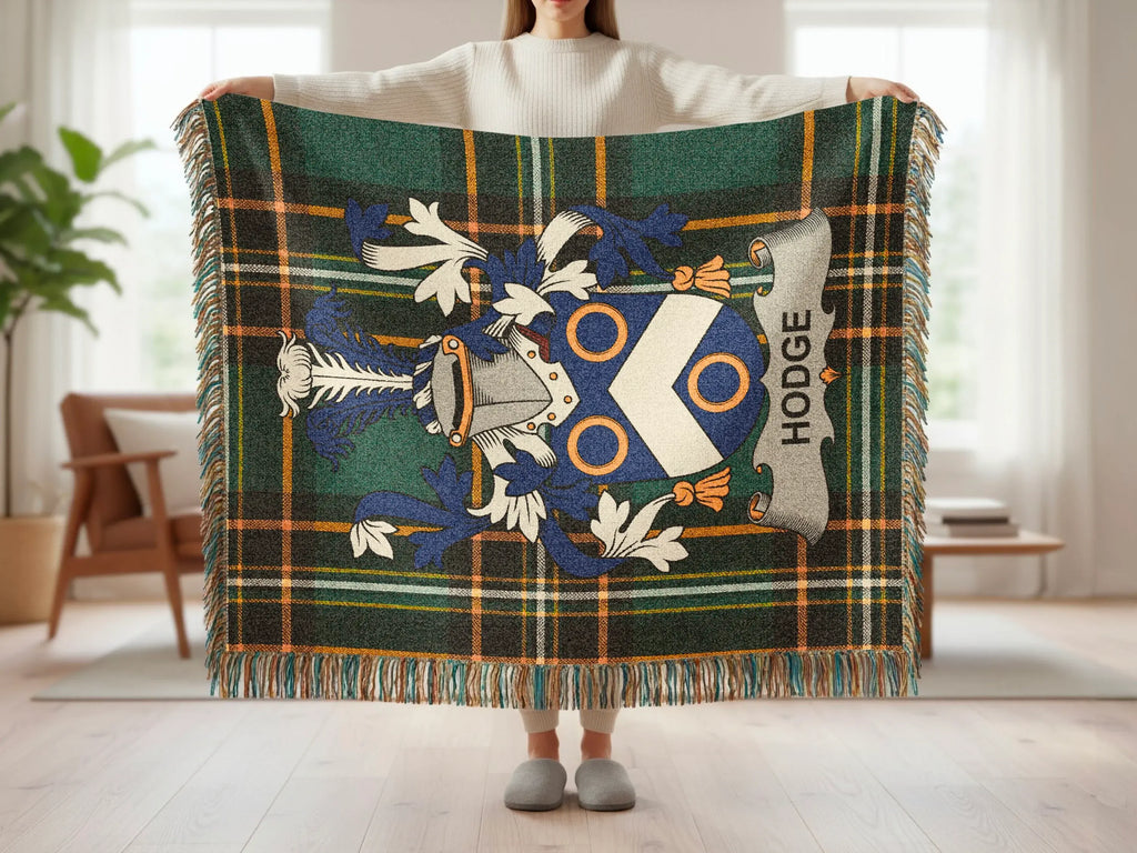 Tartan throw with Hodge family crest held by a person.