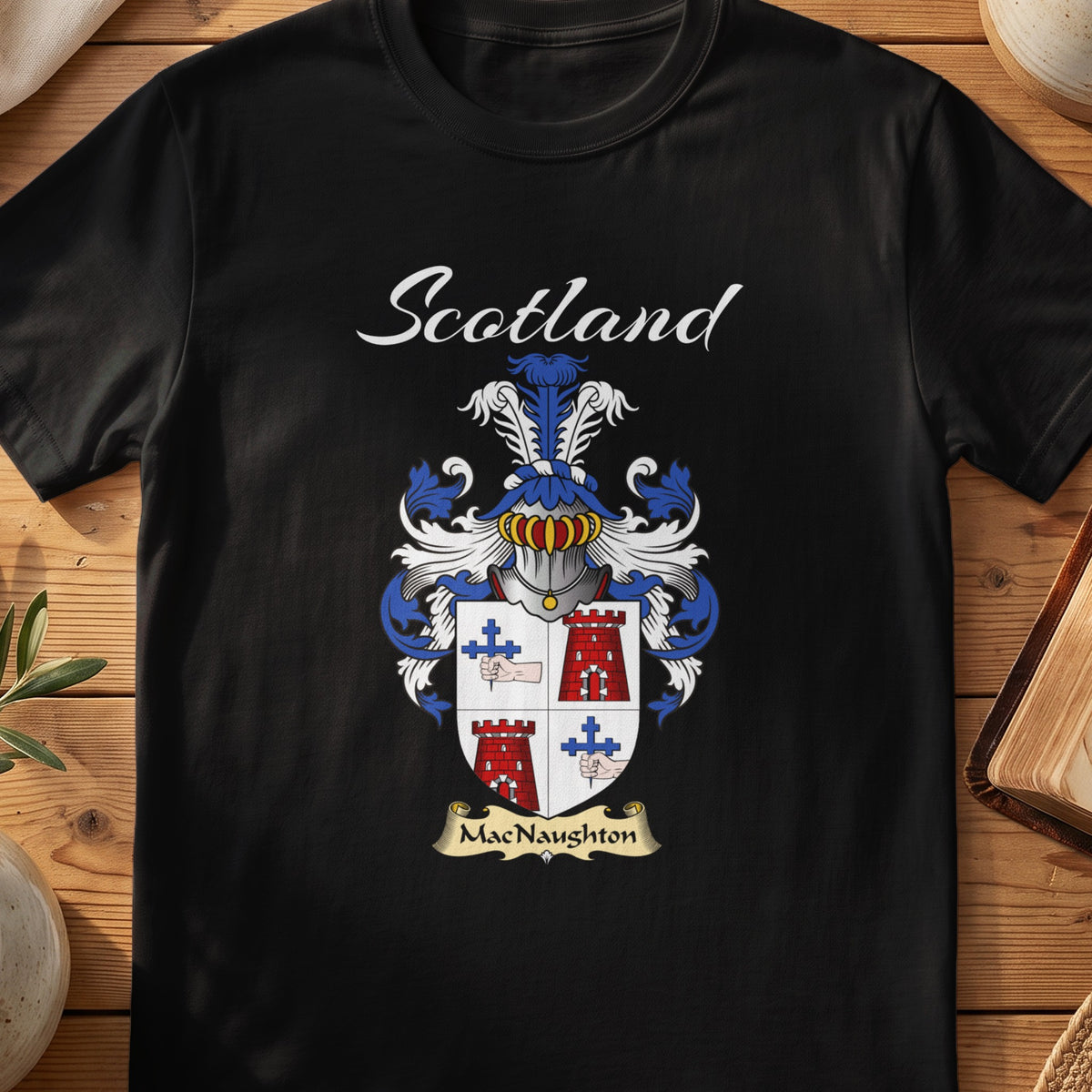 Black MacNaughton Scottish T-shirt featuring a quartered shield with red towers and blue crosses