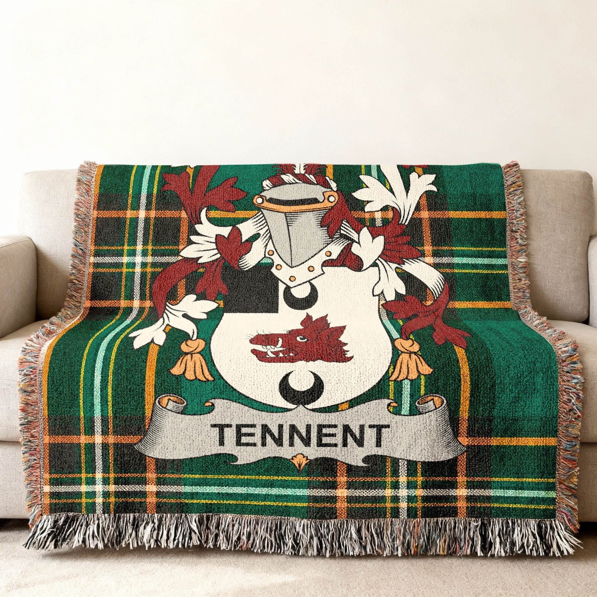Green plaid throw blanket with Tennent family crest displayed prominently.