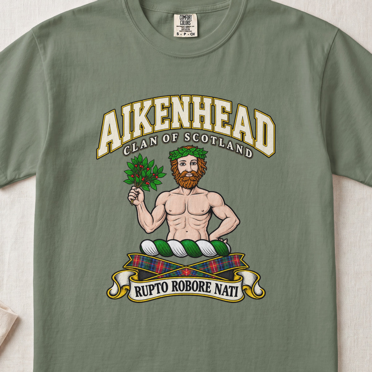 Aikenhead Scottish clan T-shirt in Moss, front view with a bearded figure holding a leafy branch and motto banner.