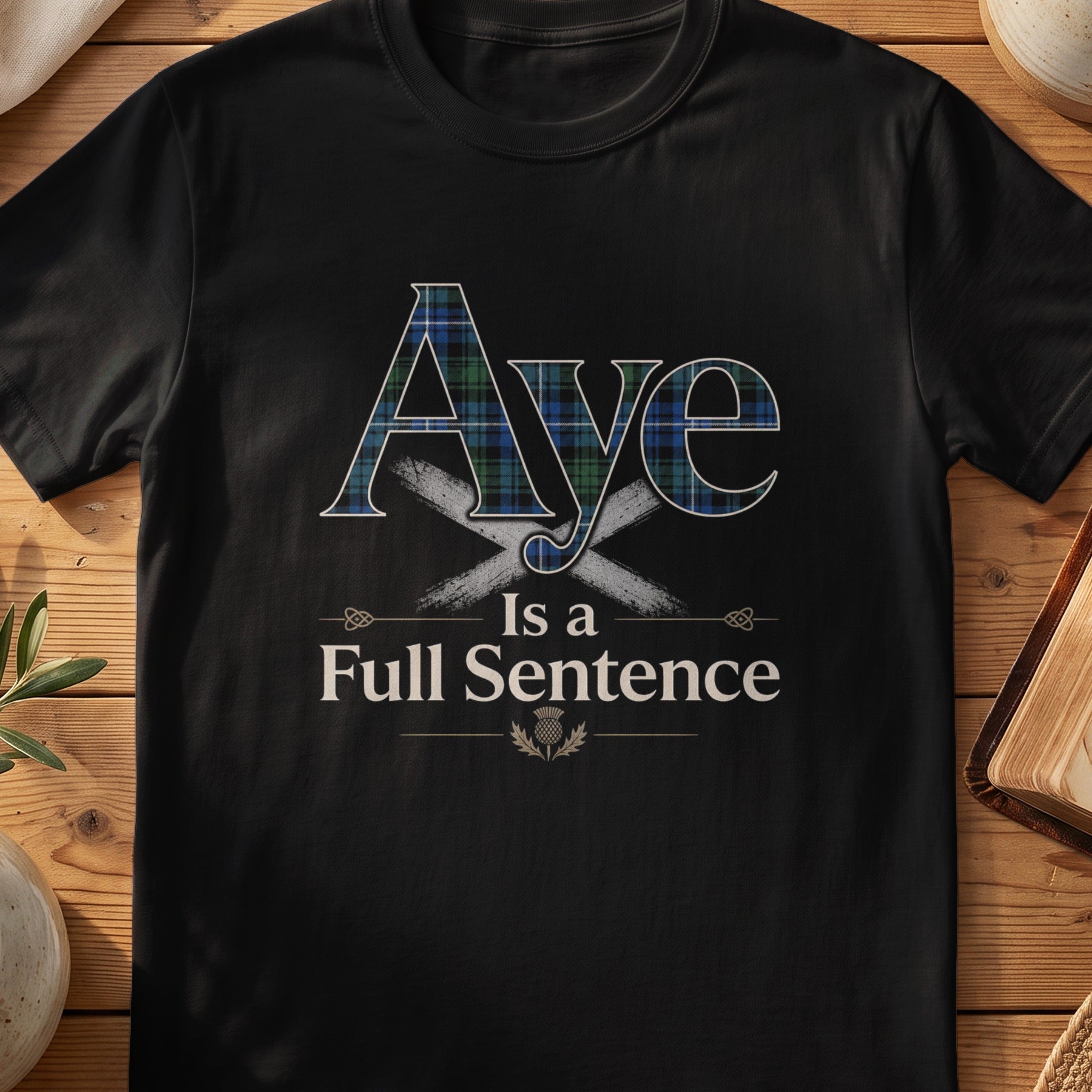 Black Gildan 64000 unisex T-shirt flatlay with Aye Is a Full Sentence Scottish graphic design